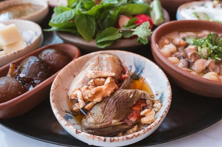 Makdous, walnut-stuffed baby eggplants, served in olive oil with fresh mint.