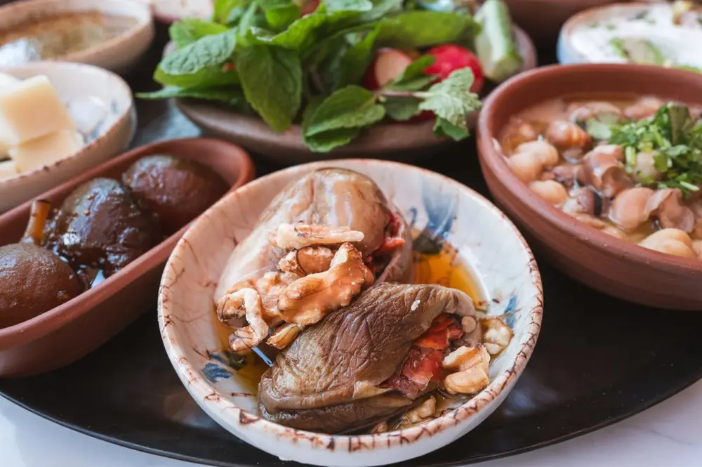 Makdous, walnut-stuffed baby eggplants, served in olive oil with fresh mint.